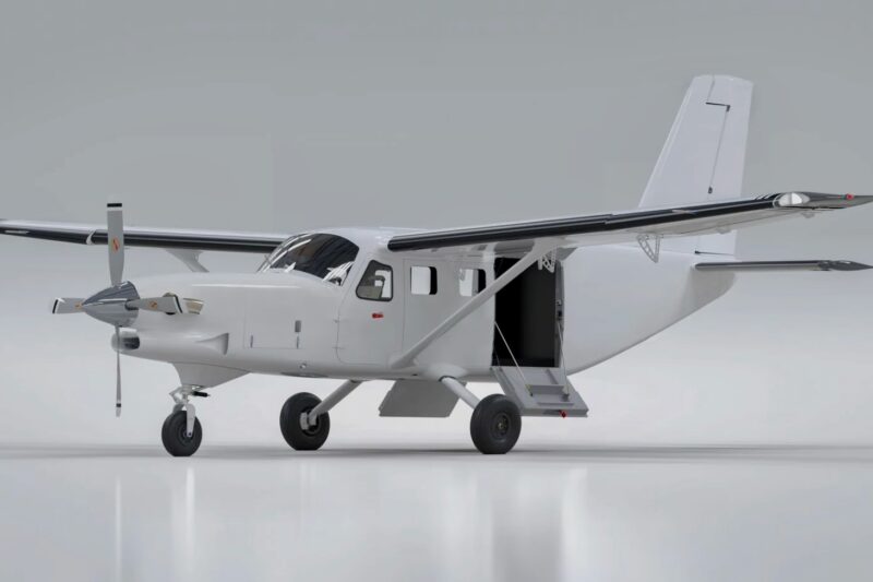 Recently Saved 1 of 1 6 White high wing single engine utility airplane with an open side door and fold out stairs on a glossy hangar floor area