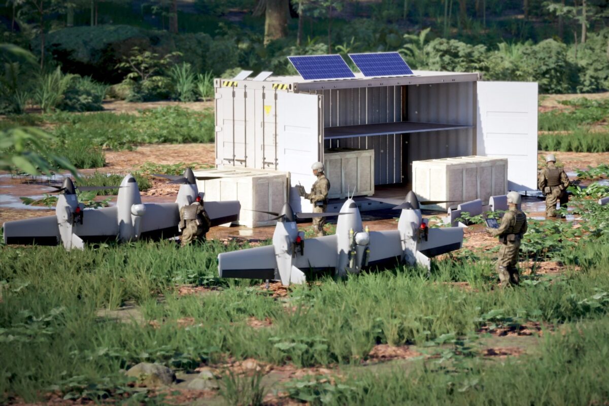 White shipping container shelter with solar panels on top crates outside and soldiers in camouflage gear in a grassy field military equipment in a training area