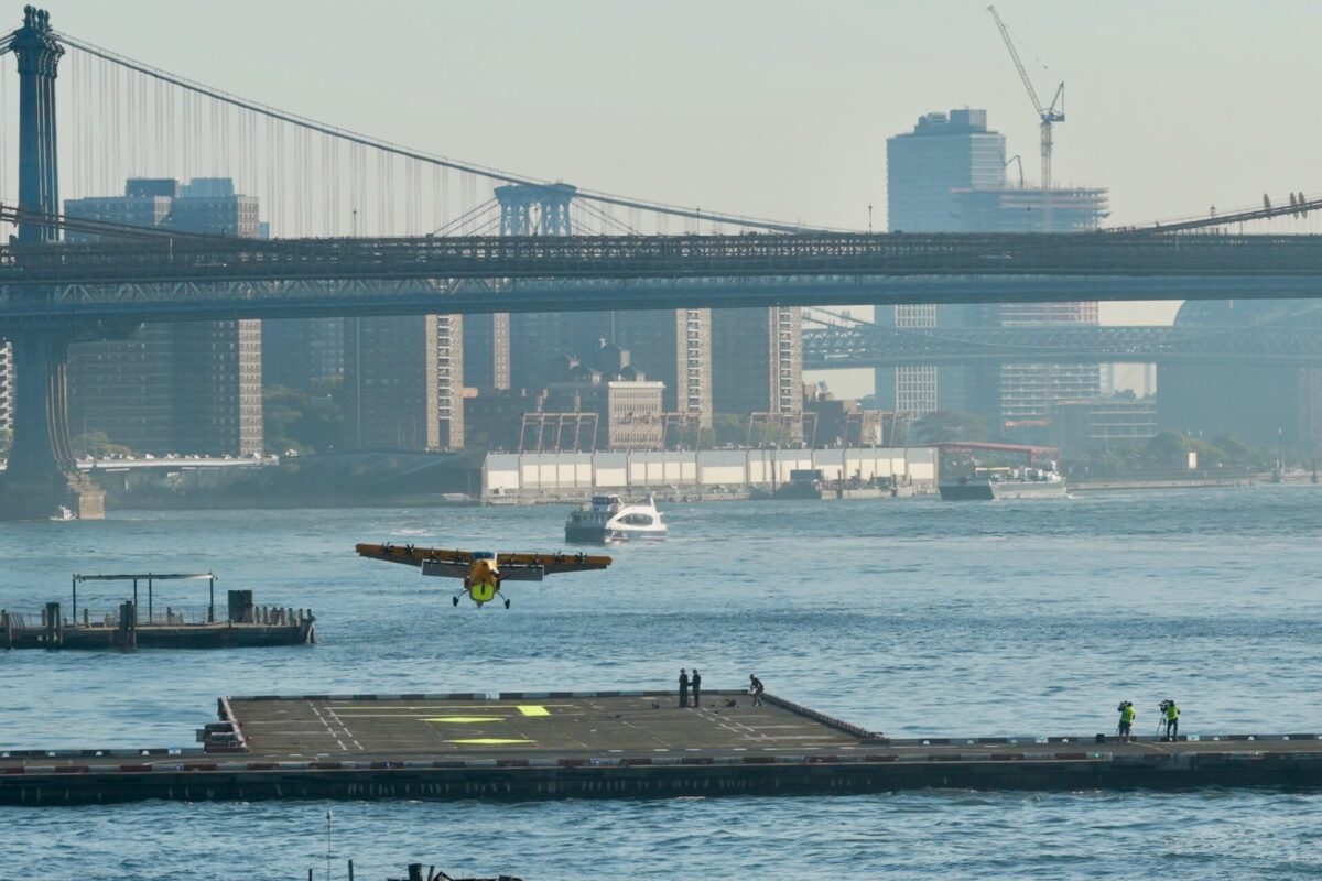 Recently Saved 1 of 1 7 Seaplane taking off from a river with city bridges and skyscrapers in the background