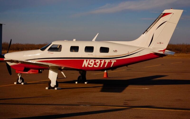 Recently Saved 1 of 1 8 Side view of a white and red Piper private airplane with tail number N931TT parked on an airport tarmac gear down sunny day