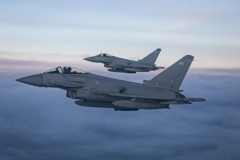 Two Royal Air Force Typhoon fighter jets fly in formation during a NATO training exercise