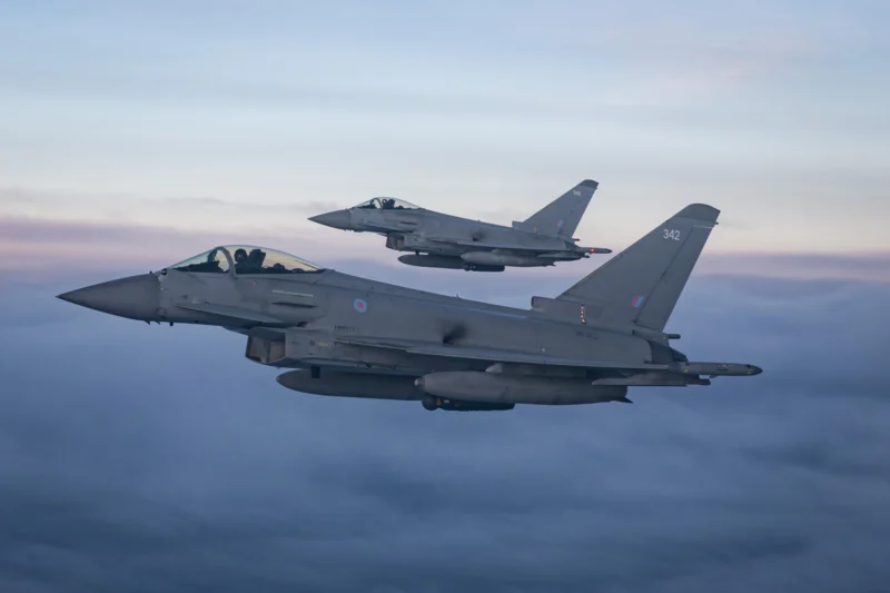 Two Royal Air Force Typhoon fighter jets fly in formation during a NATO training exercise