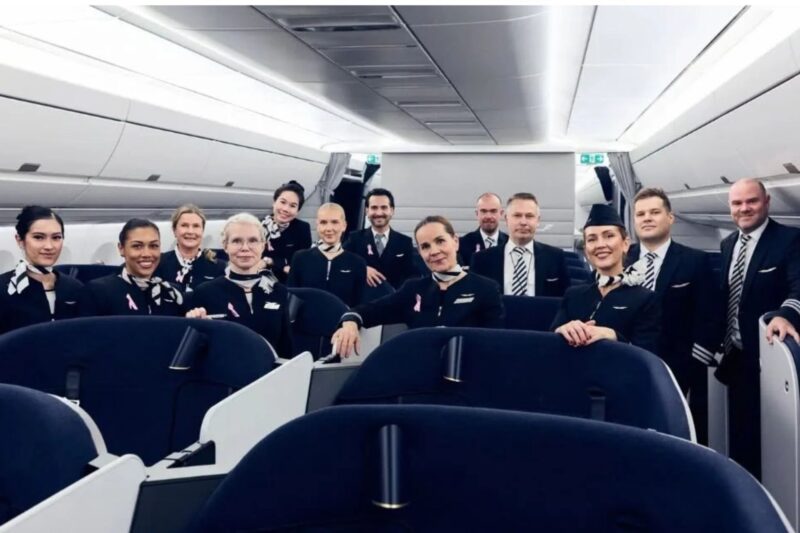 Finnair launches HelsinkiMelbourne flights via Bangkok Group of flight attendants in uniform posing together inside an airplane cabin for a crew photo