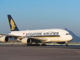 Singapore Airlines Airbus A380 on the taxiway tail fin with the gold logo four engines visible against a clear blue sky
