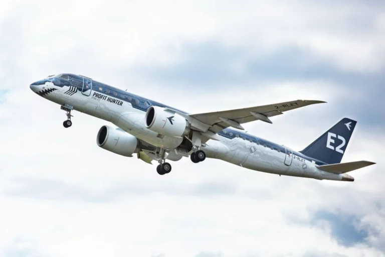 Commercial airplane in flight with Profit Hunter livery engines under wings landing gear extended tail marked E2