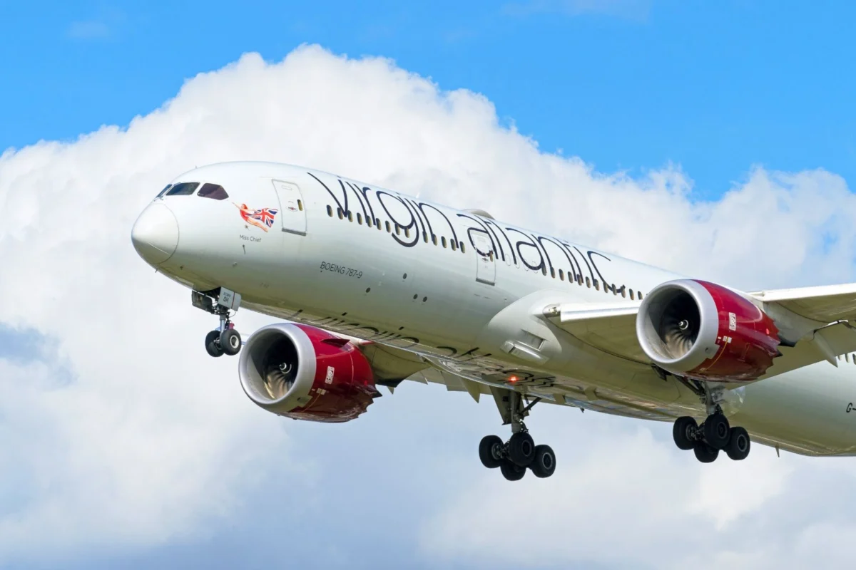 Virgin Atlantic launches first nonstop Heathrow Phuket route Commercial jet in ascent with two red engines nose forward against a blue sky with clouds