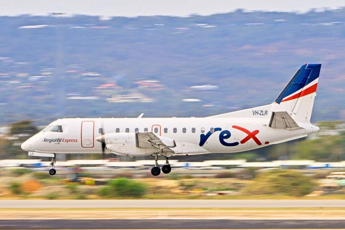Ex Rex chairman fined US0000 banned from managing firms Regional Express airplane taking off on runway full view of fuselage and bluered tail livery VH ZLR