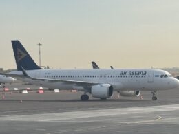 Air Astana passenger jet taxiing on the tarmac at an airport blue tail logo visible