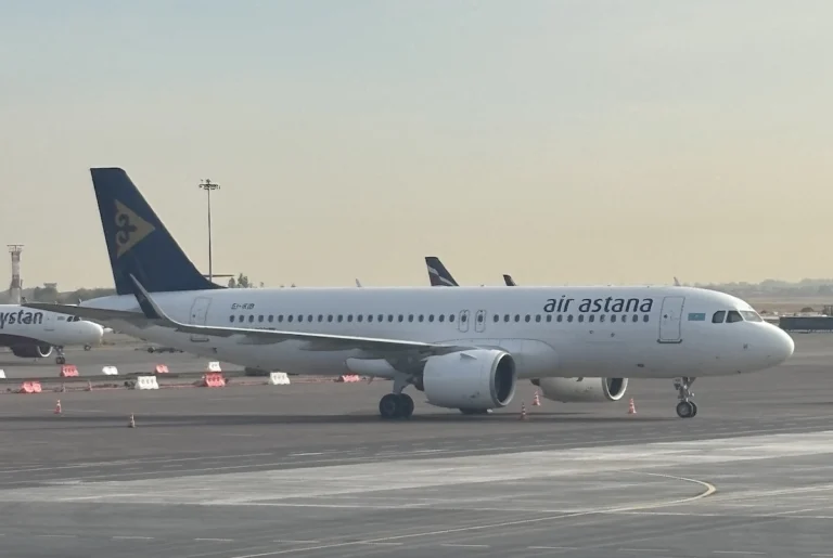 Air Astana passenger jet taxiing on the tarmac at an airport blue tail logo visible