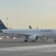 Air Astana passenger jet taxiing on the tarmac at an airport blue tail logo visible