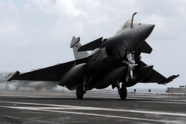 A French Dassault Rafale fighter aircraft conducts touch and go landings aboard the aircraft carrier USS Dwight D Eisenhower