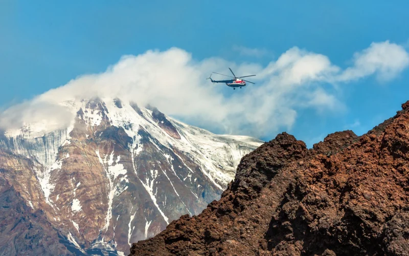 A helicopter flies in Kamchatka, Russia