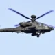 An AH-64E Apache attack helicopter