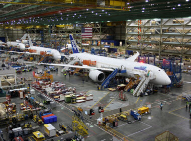Unidentified Boeing employees continue work building a Boeing 787 jets at its Everett factory
