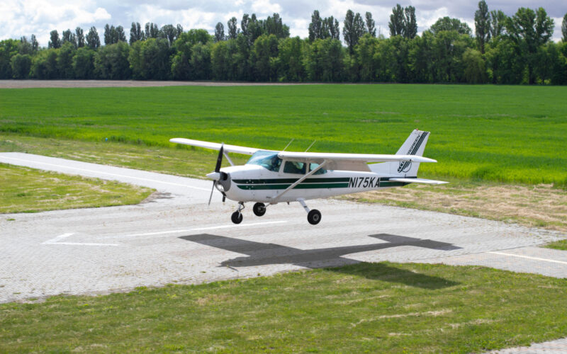 Cessna 172 is landing. Small airplane in the sky, student is learning how to land on the ground.