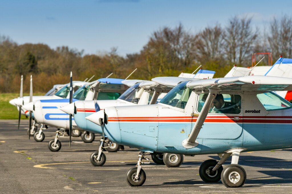 Cessna Aerobat light trainer aircraft parked in a line at Wycombe Air Park