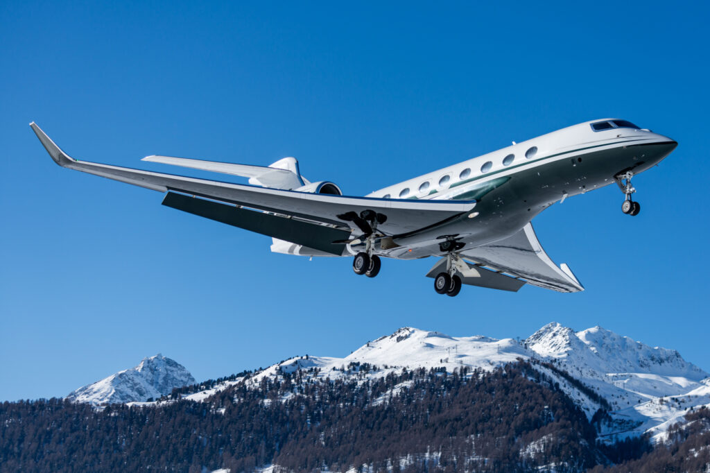 Business jet during landing at Engadin airport during the winter holidays in Switzerland.