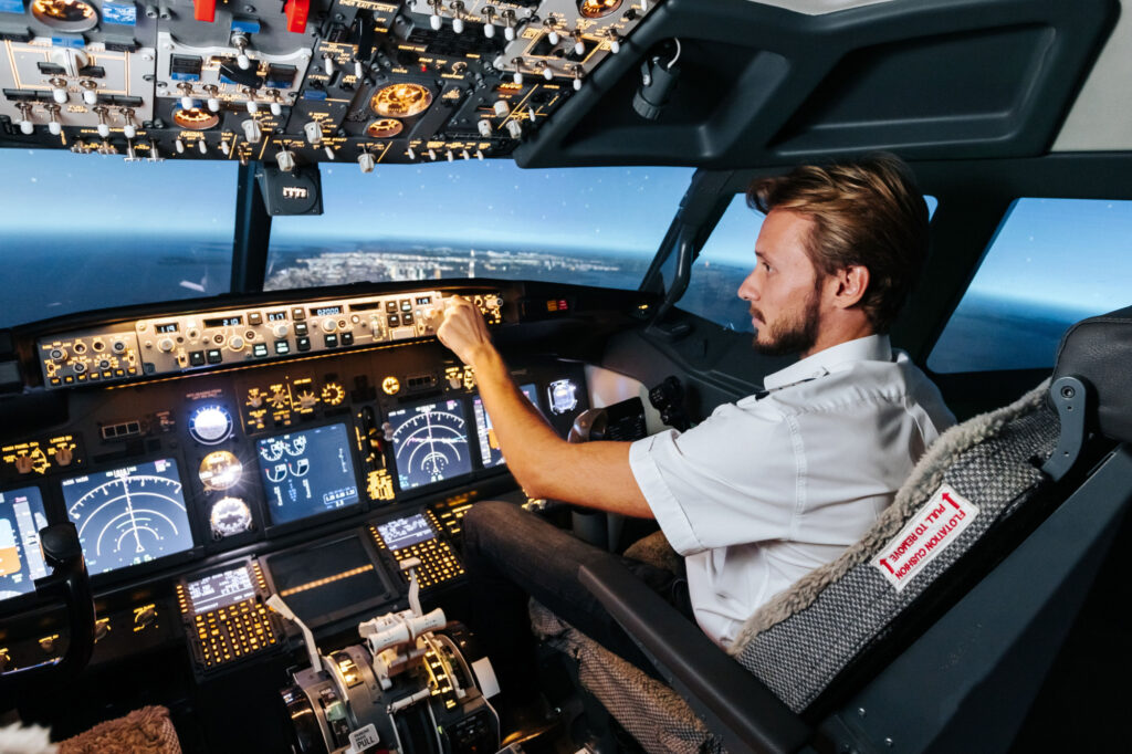 First officer is controlling autopilot and parameters for safety flight. Cockpit of Boeing aircraft.