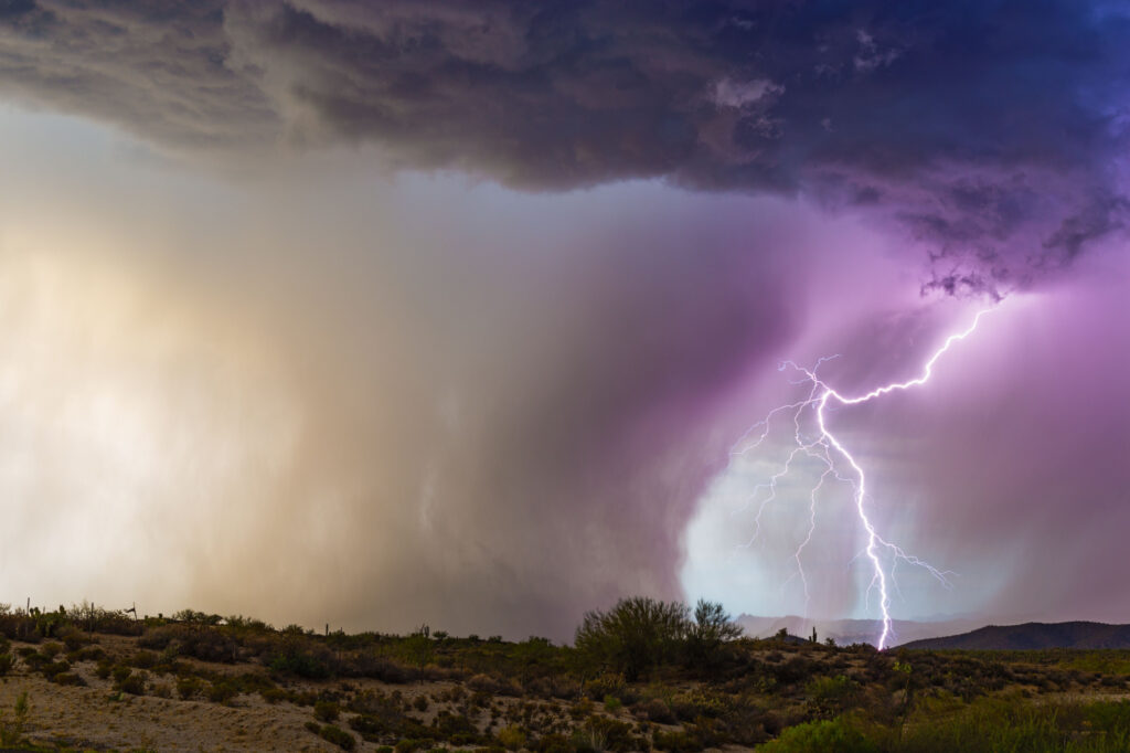 Lightning illuminates a microburst from a monsoon thunderstorm in the Arizona desert