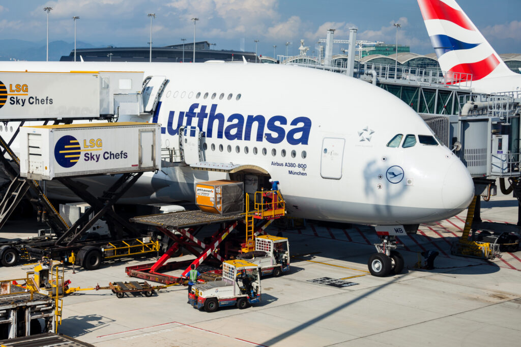 A Lufthansa A380 aircraft is being catered and cleaned as passengers disembark while cargo is unloaded after arriving at Hong Kong International Airport