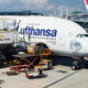 A Lufthansa A380 aircraft is being catered and cleaned as passengers disembark while cargo is unloaded after arriving at Hong Kong International Airport