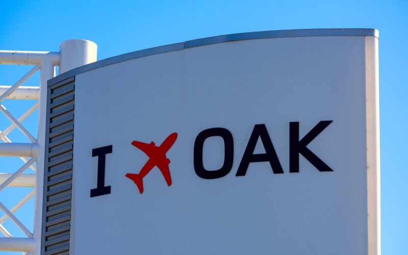 I,Fly,Oakland,Sign,With,Red,Airplane,Logo,On,The