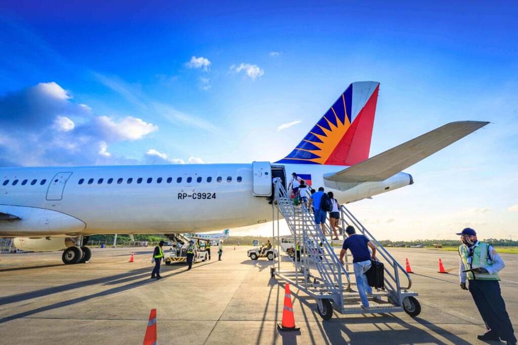 Passengers boarding Philippine Airlines plane