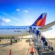 Passengers boarding Philippine Airlines plane