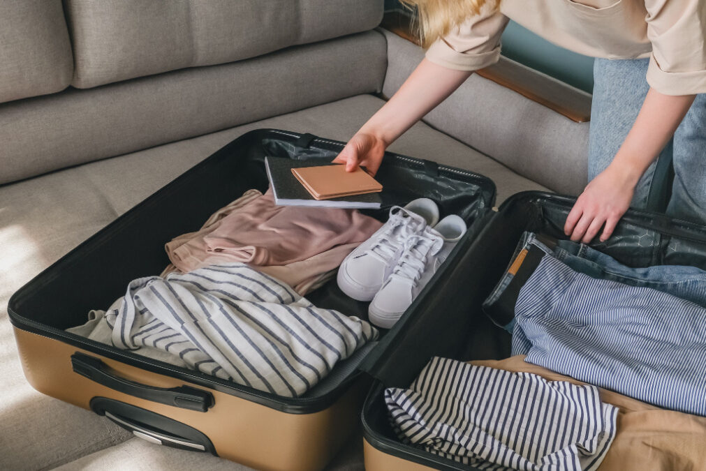 TraveltourismGirl packing suitcase for travel