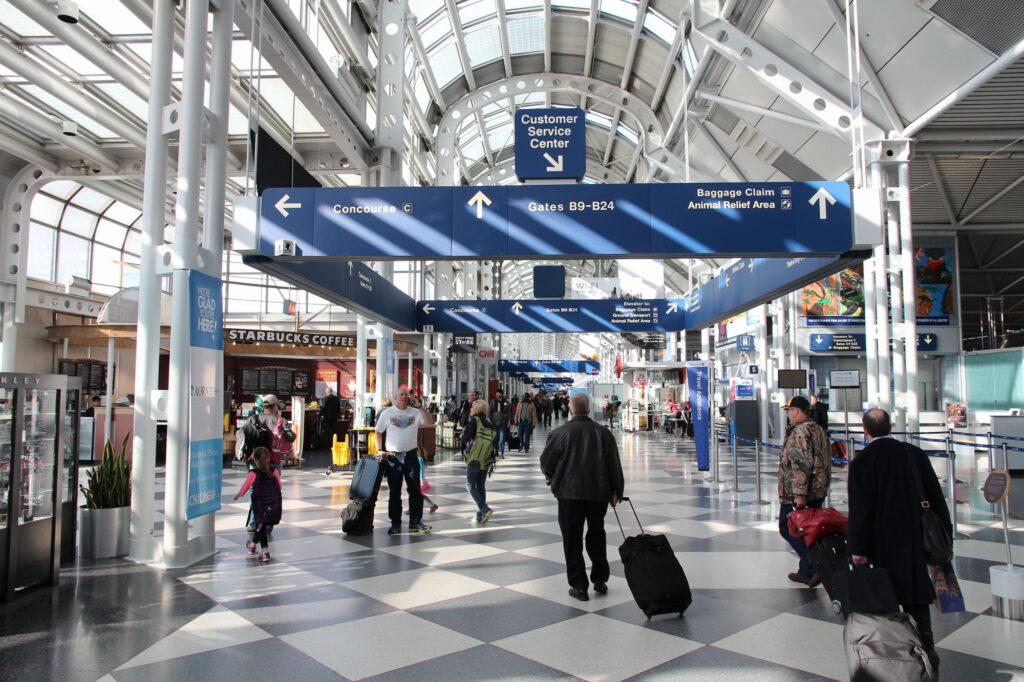 Travelers walk to gates at Chicago O'Hare International Airport
