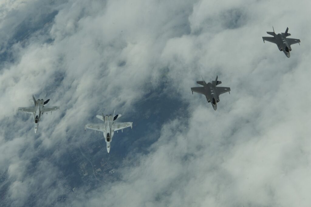 USAF F-35s fly with Finnish F-18s