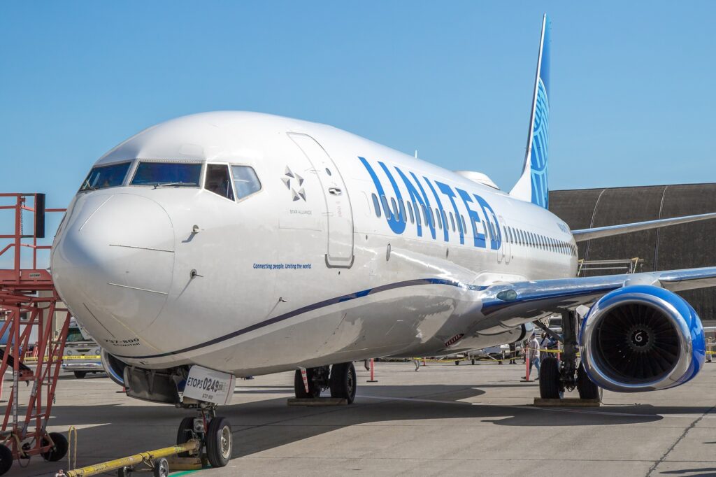 A United Airlines Boeing 737-900ER suffered significant damage to its fuselage following an American Airlines baggage cart hitting it at ORD