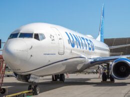 A United Airlines Boeing 737 900ER suffered significant damage to its fuselage following an American Airlines baggage cart hitting it at ORD