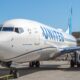A United Airlines Boeing 737 900ER suffered significant damage to its fuselage following an American Airlines baggage cart hitting it at ORD