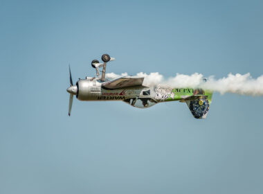 Airshow "Wings over Baltics Airshow 2019”. Airplane performing at airshow and leaves behind a smokes in the sky. Upside-down flight.
