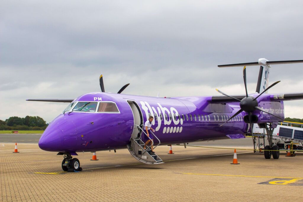 a_flybe_dash_8_commercial_airliner_with_luggage_and_passenger_handlers_on_the_apron_at_southampton_city_airport_in_hampshire_england-min_1.jpg