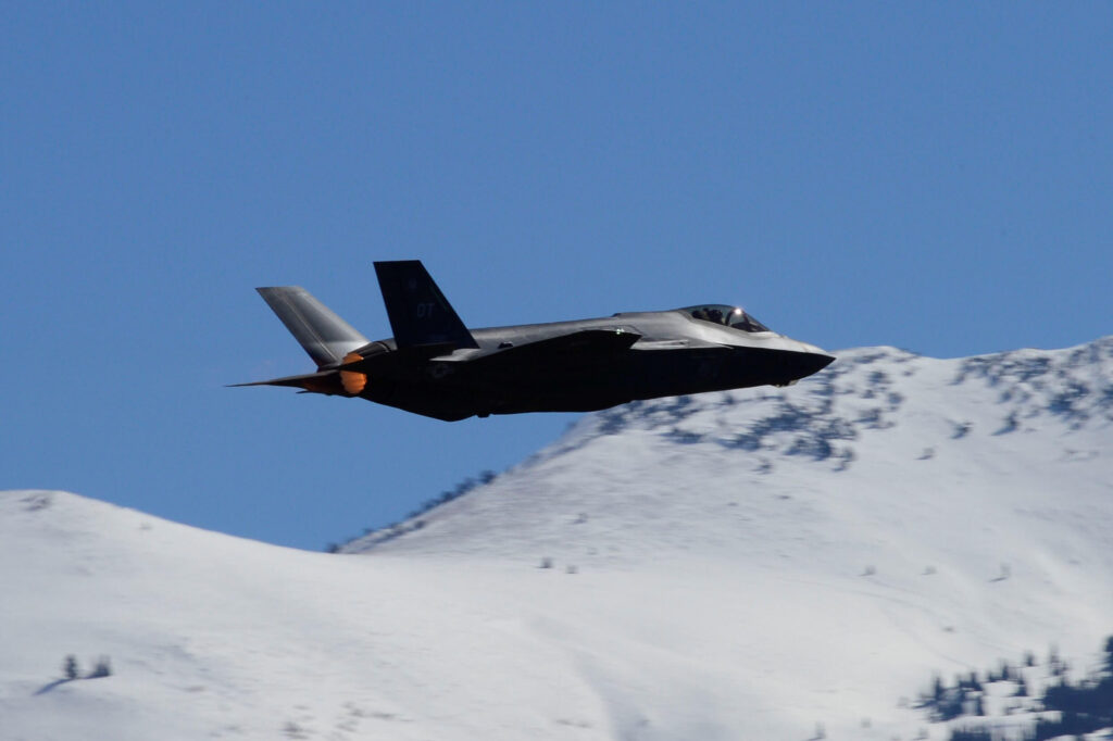 a usaf f 35a lightning ii aircraft flying by snowy mountainsjpg a_usaf_f-35a_lightning_ii_aircraft_flying_by_snowy_mountains.jpg