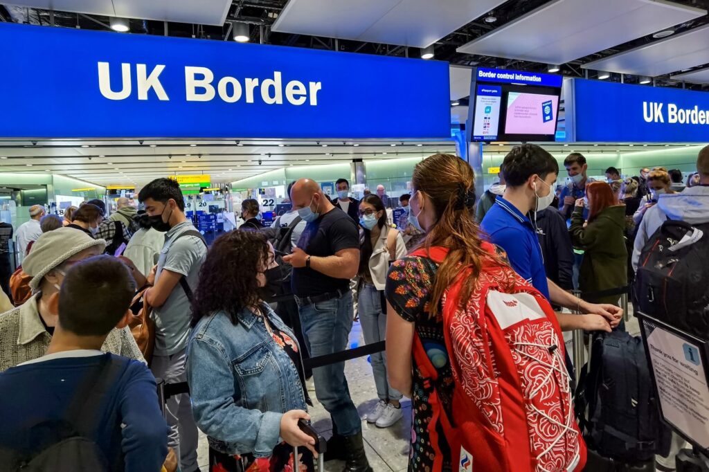 air_travelers_queuing_at_uk_border_control_in_heathrow_airport_london.jpg