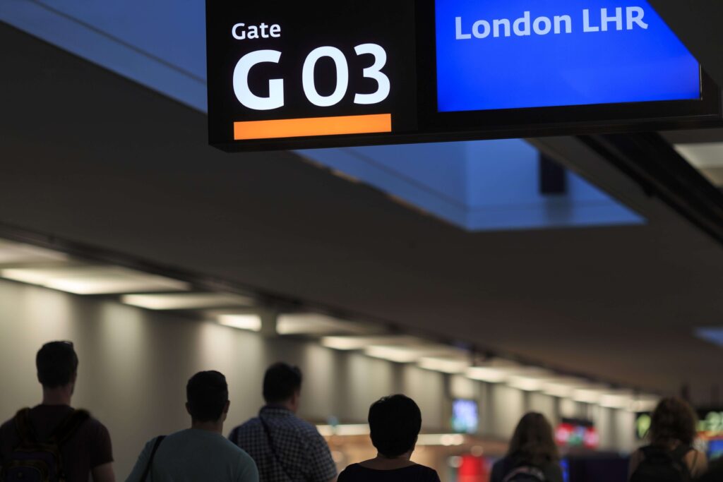 airport_interior_with_passenger_silhouettes_gate_number_three_board_and_destination_london_heathrow_airport_lhr-min.jpg