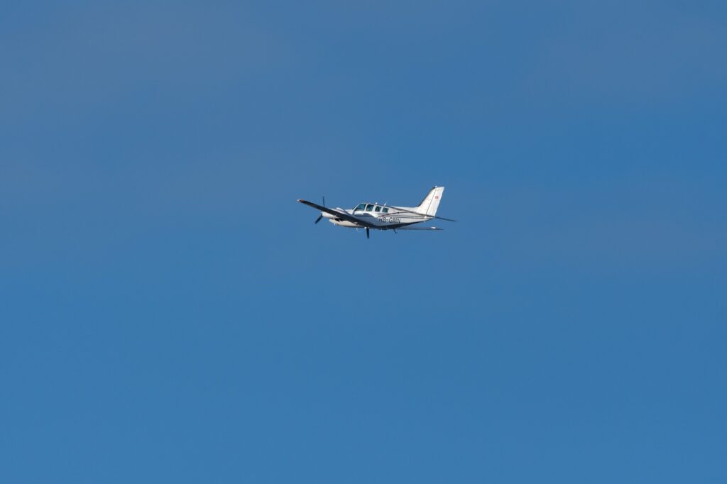 Beechcraft Baron 58 propeller plane leaving from runway