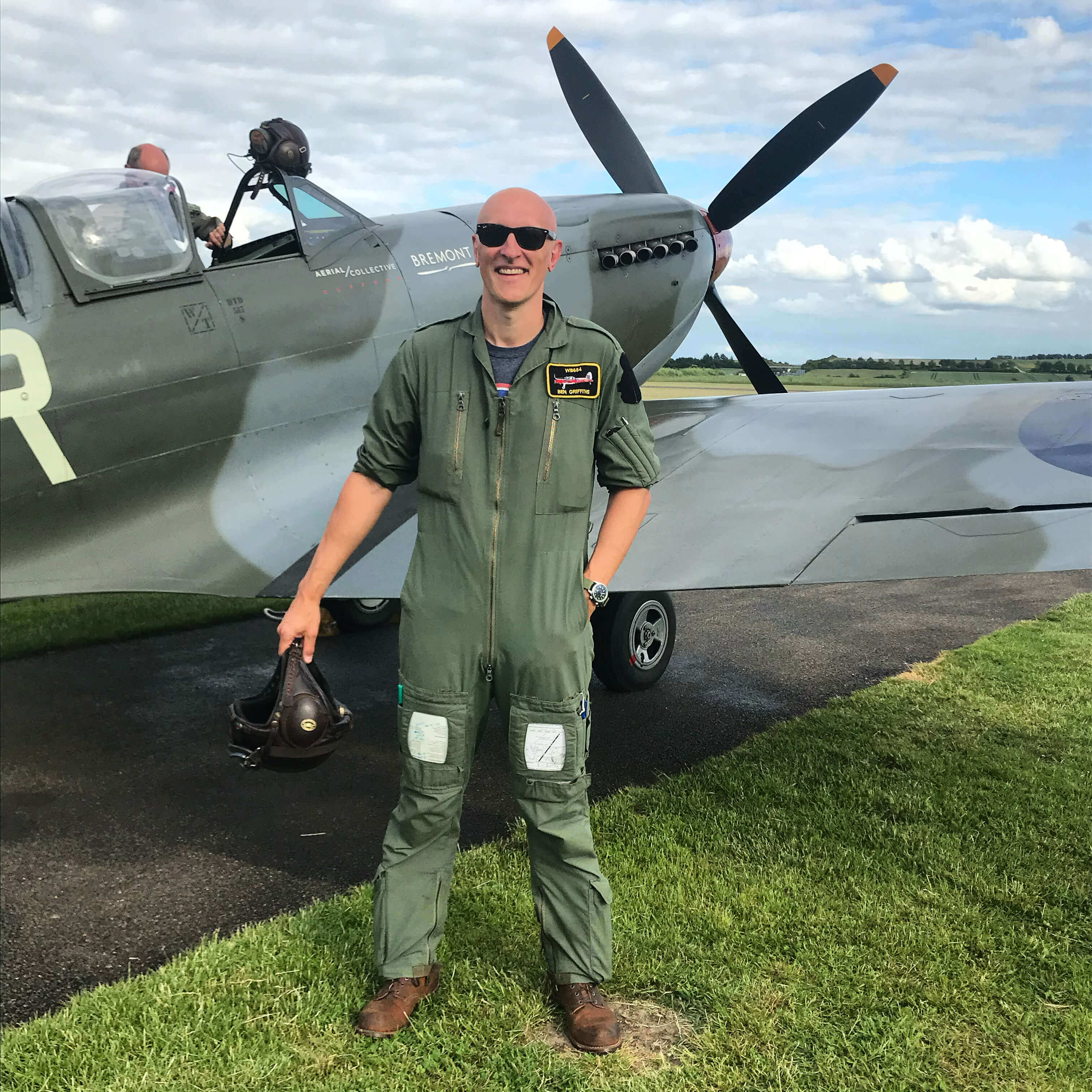 Ben Griffiths stands next to the Spitfire