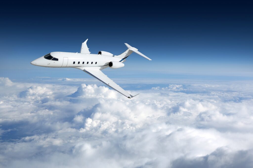 Business aviation jet airplane flying on a high altitude above the clouds