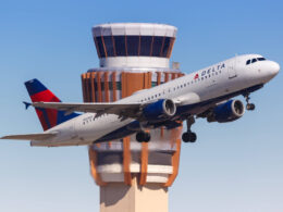 delta_aircraft_in_front_of_atc_tower.jpg