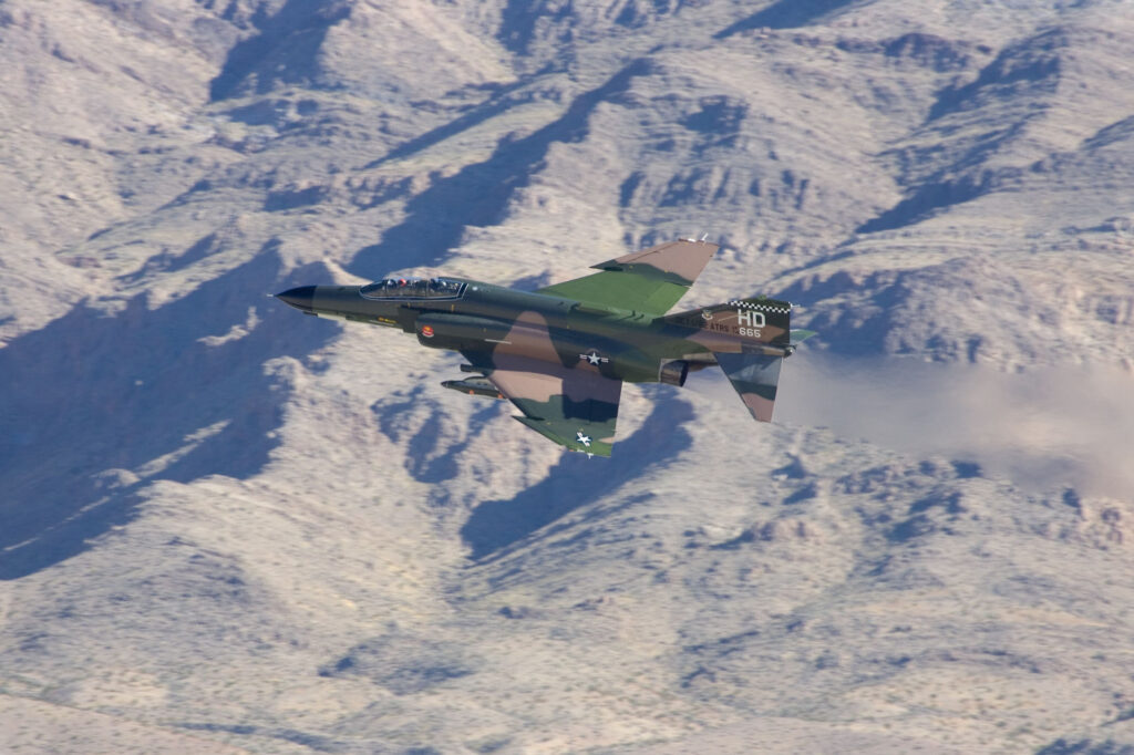 F 4 Phantom jet in a white snowy mountains background