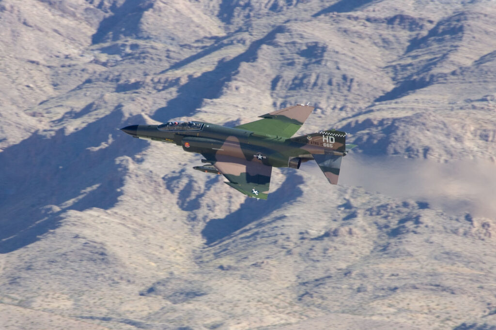 F-4 Phantom jet in a white snowy mountains background