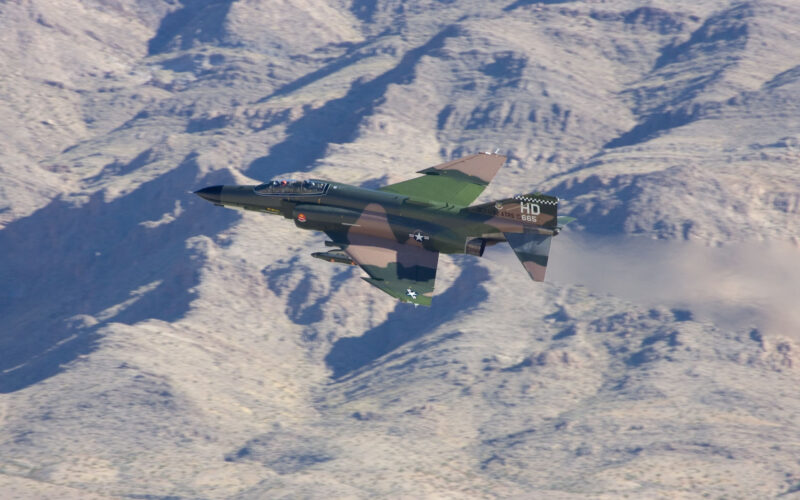 F-4 Phantom jet in a white snowy mountains background