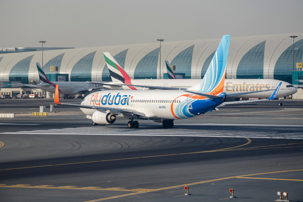 flydubai_boeing_737_and_emirates_777_in_the_background_at_dubai_international_airport_dxb.jpg