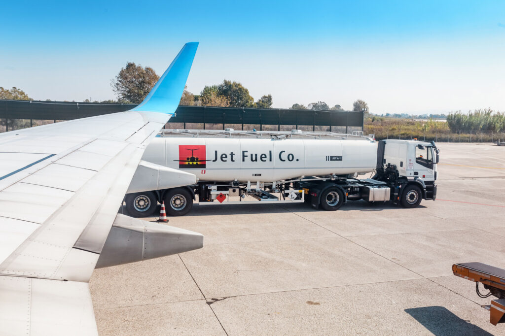 fuel kerosene truck near plane at airport runway