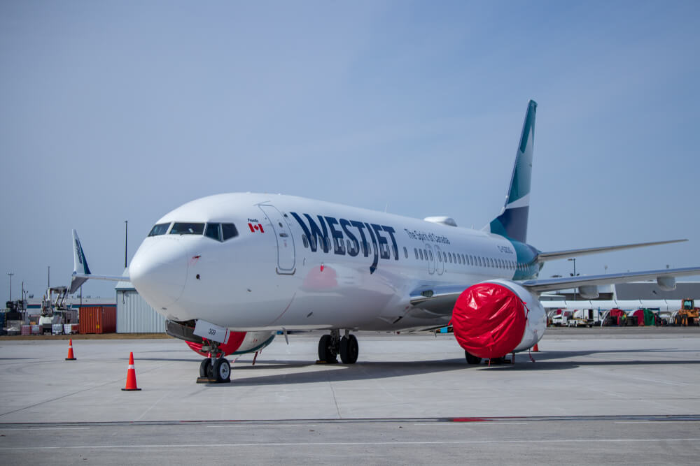 grounded_westjet_737_max8_sits_on_the_ramp_at_john_c._munro_hamilton_international_airport_yhm_with_engines_covered.-1.jpg