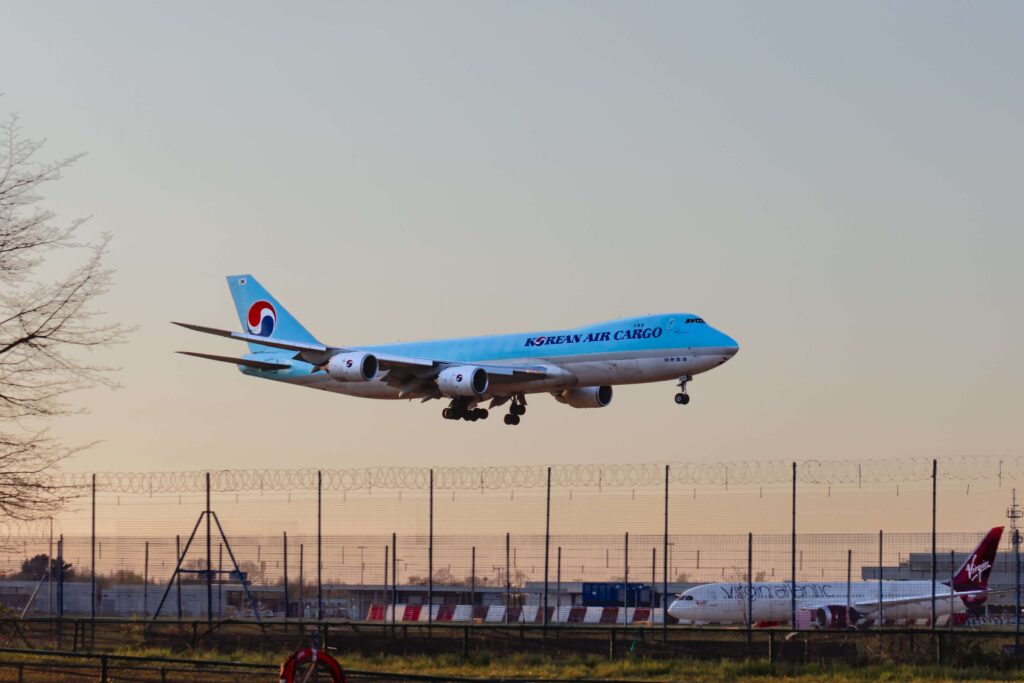 heathrow_london_uk_april_2021_korean_air_cargo_boeing_747_jumbo_jet_cargo_plane_coming_in_to_land_at_heathrow_airport_as_it_flys_past_a_blurry_virgin_atlantic_boeing_787..jpg